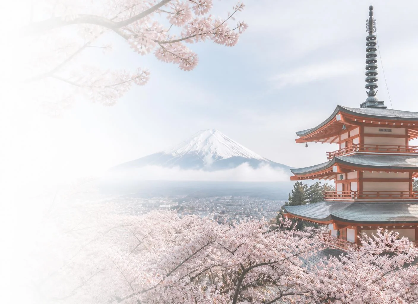 Mount Fuji framed by cherry blossoms and a Japanese pagoda